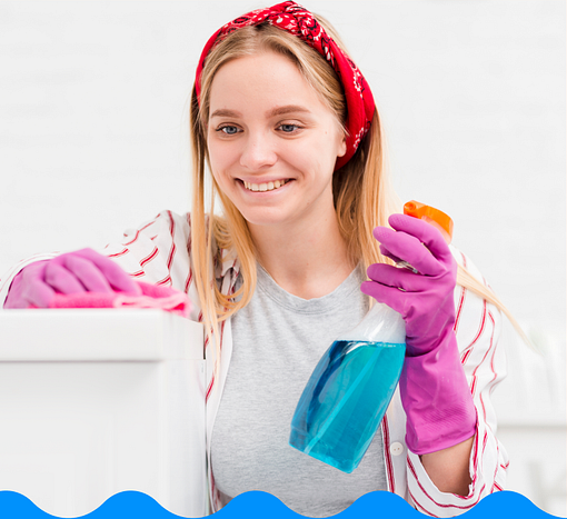 Smiling cleaner holding a spray bottle